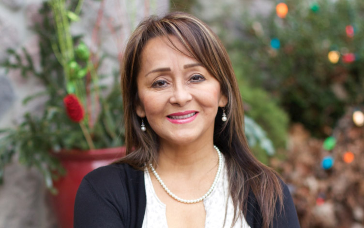 A woman with long hair and a necklace.